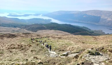 Walkers clibing Ben Lomond cared for by the National Trust for Scotland