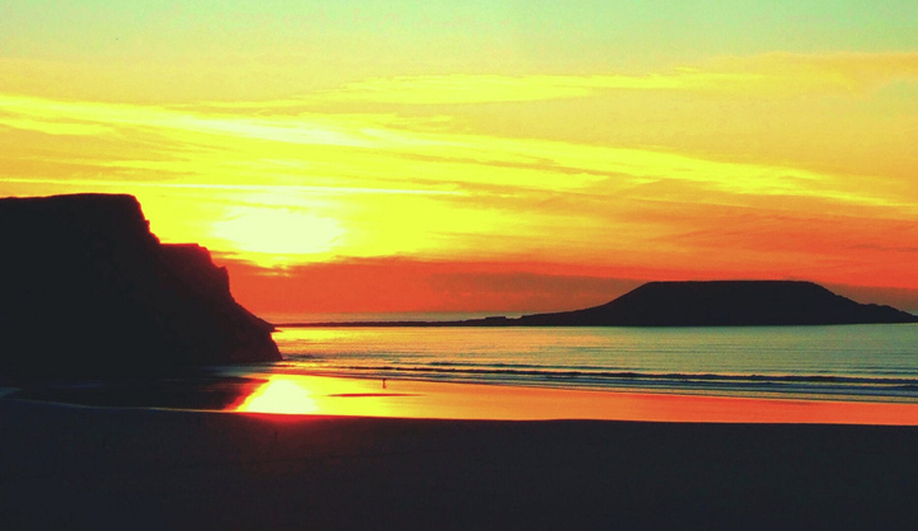 sunset over the seaside from chapel house on the gower