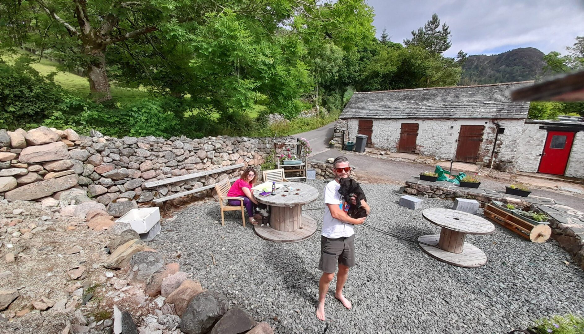 family with dog outside wild wool barn
