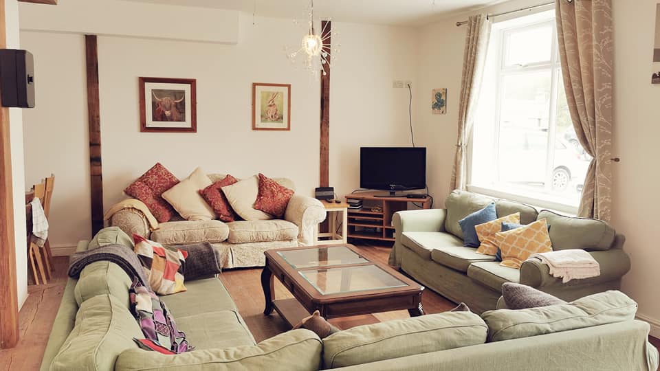 A large lounge with log burner and TV, ideal for christmas gathering