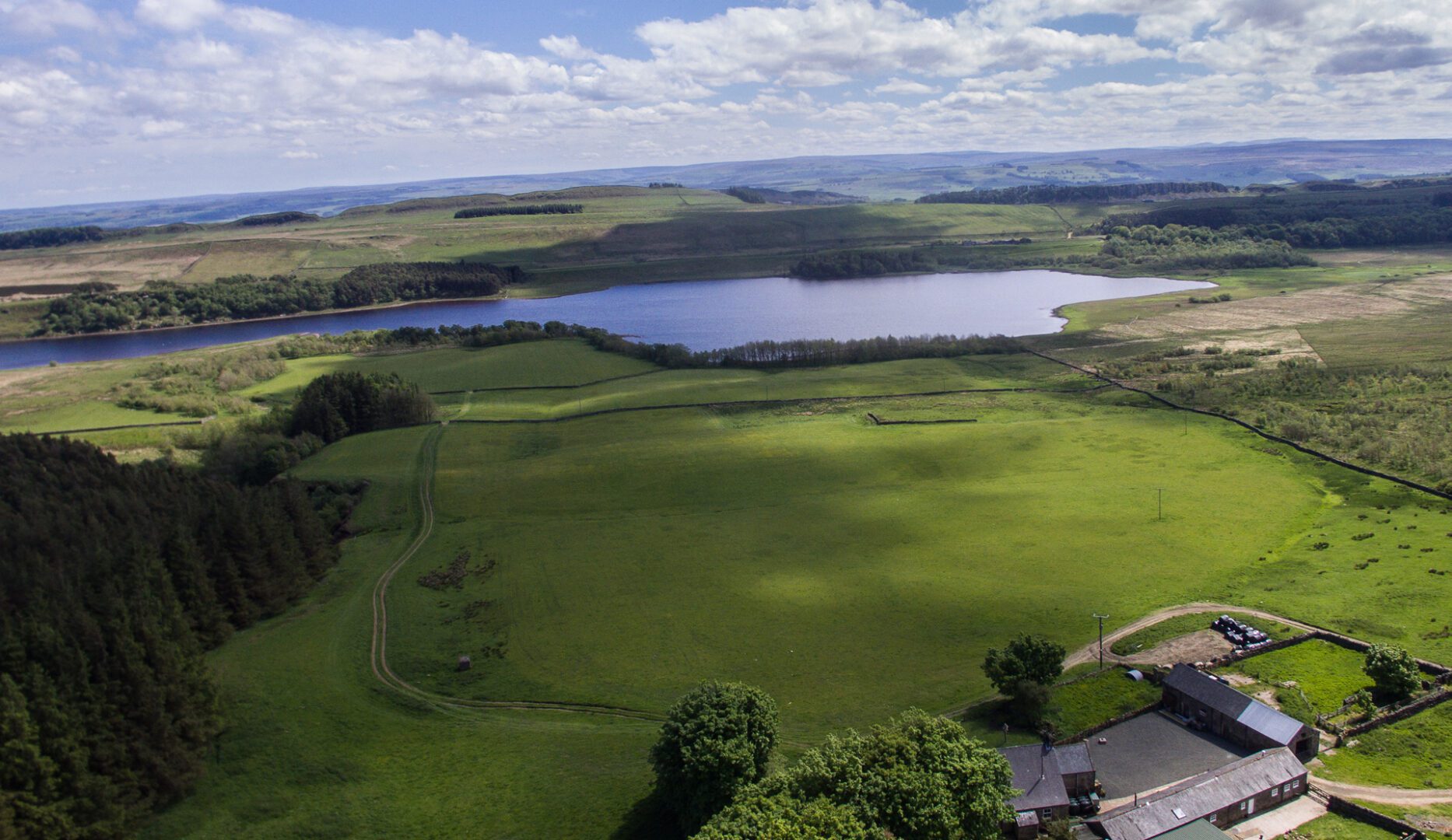 View over green fields to lake