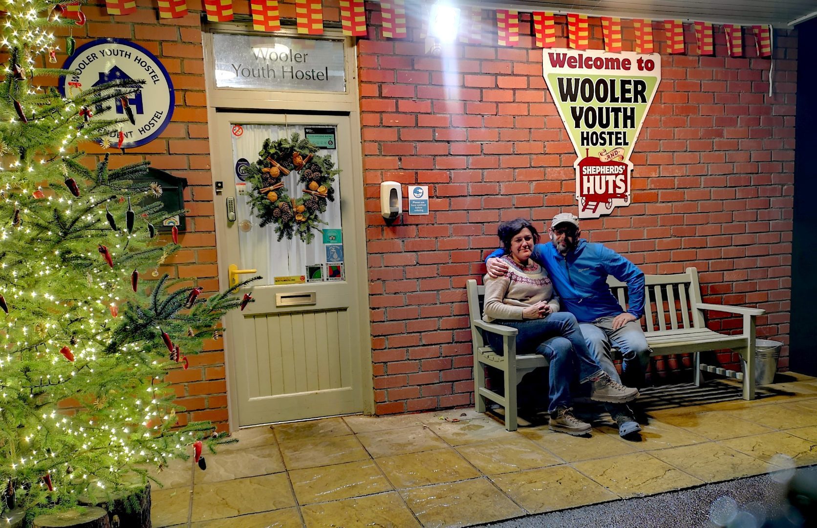 Christmas tree and couple celebrating New Year outside Wooler Youth Hostel
