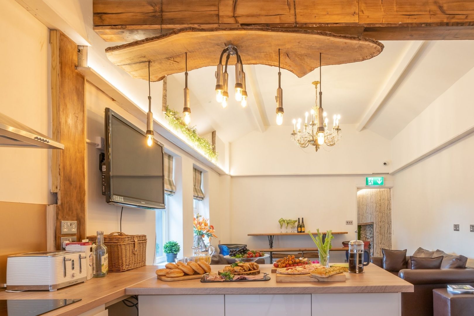 Modern kitchen, wooden surfaces, white walls, dangling lights