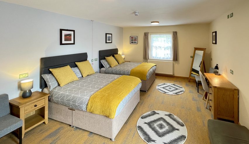 Accessible bedroom with two double beds