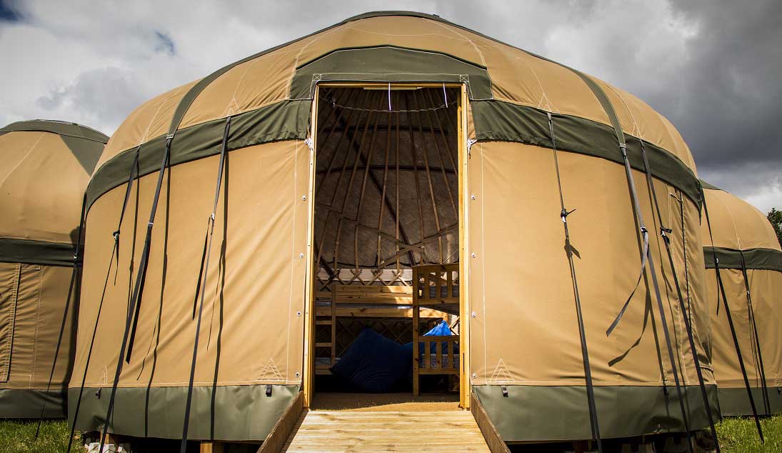 Yurt with open door showing wooden bunks