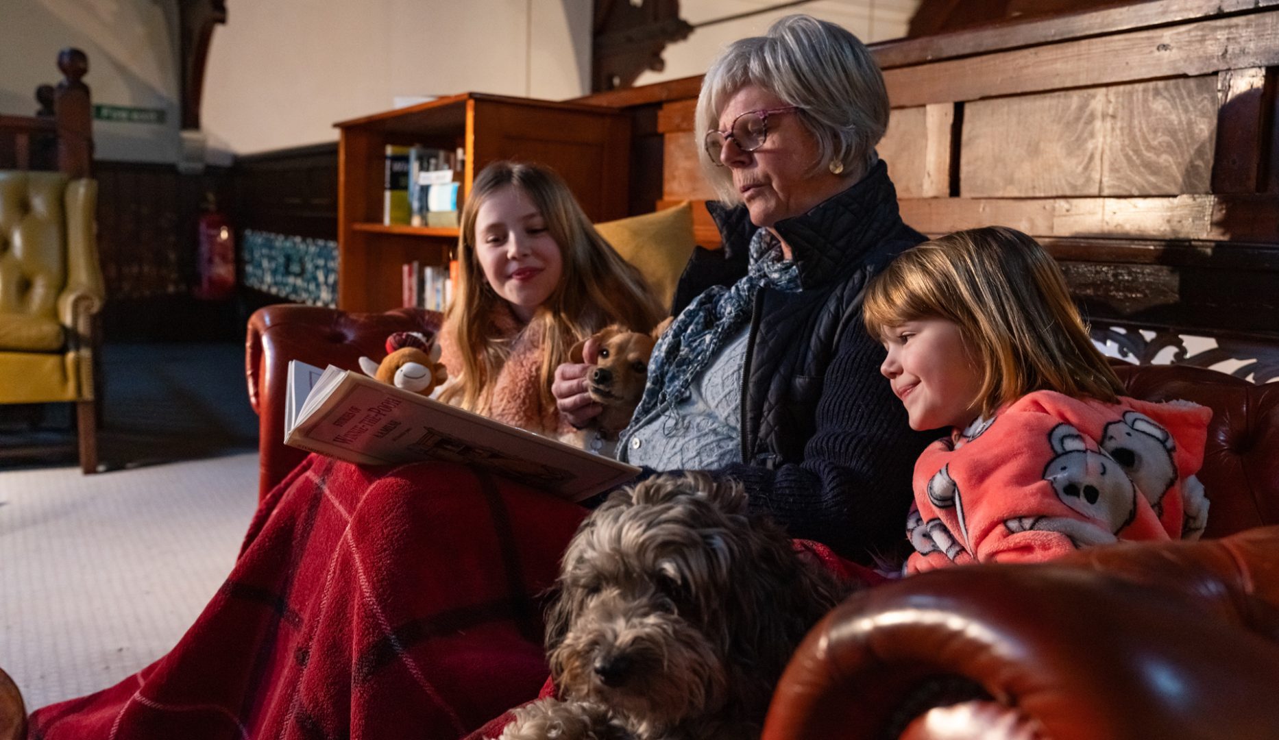 grandma reading to children at Kirkby Stephen Hostel