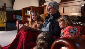 grandma reading to children at Kirkby Stephen Hostel