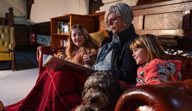 grandma reading to children at Kirkby Stephen Hostel