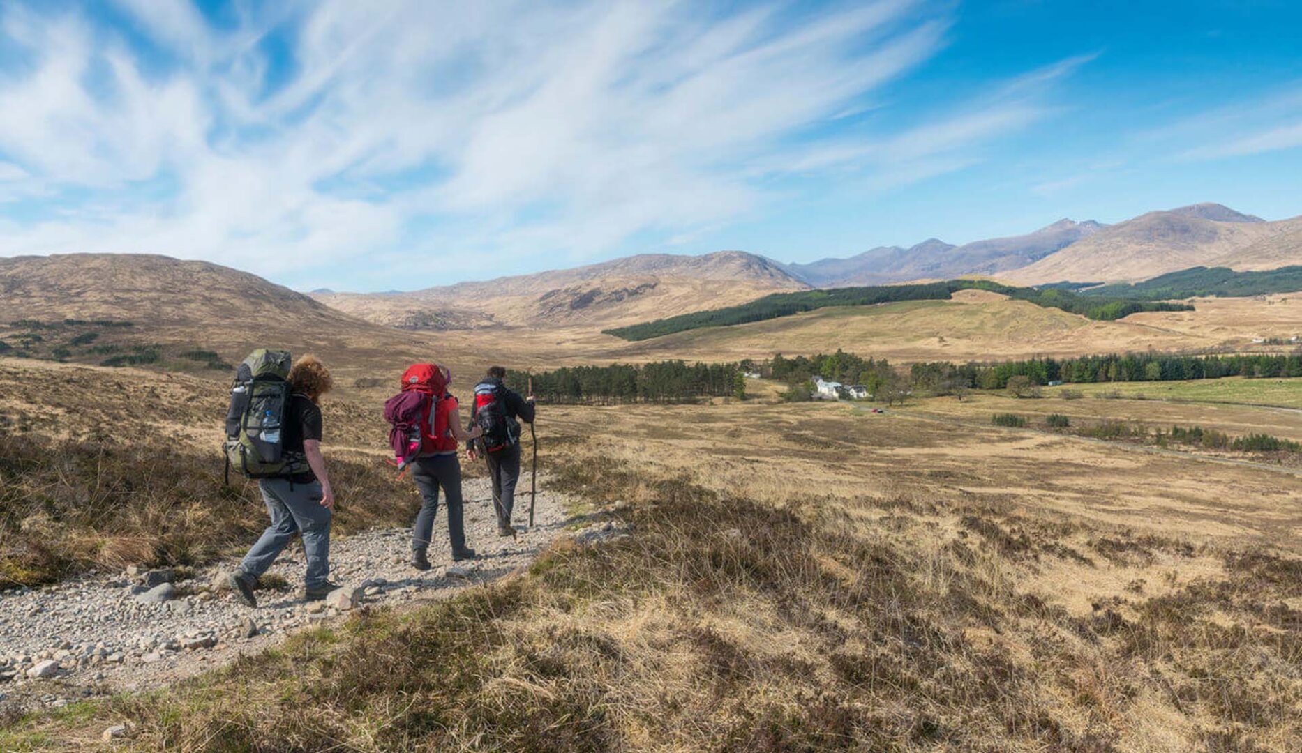 walkers on the west highland way showing kinghouses bunkhouse in the background