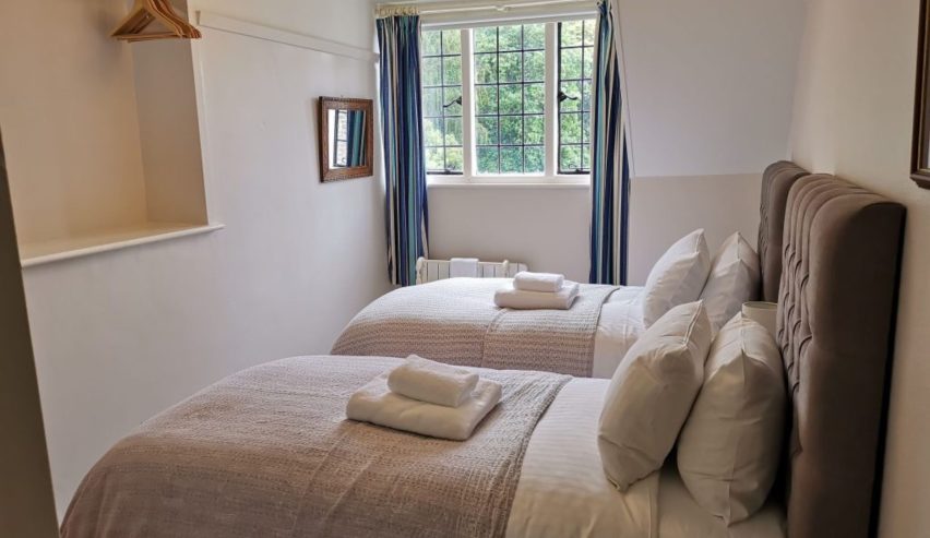 Twin room, with fluffy towels on the beds