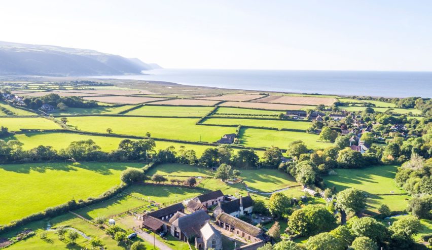 Aerial view of the bunkhouse across fields to the sea