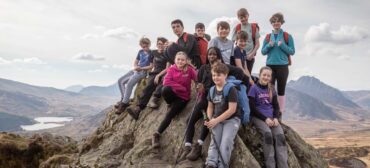 school group on top of a mountain in north wales while at a school residential at white peris
