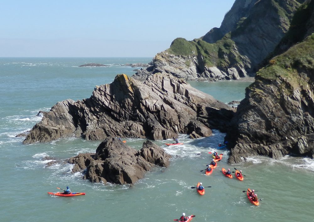 children canoing on a school residential trip at ocean backpackers