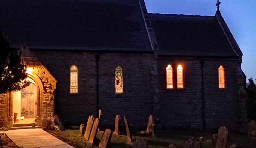 St.Michael's Lodge hostel at night with the light glowing from the windows