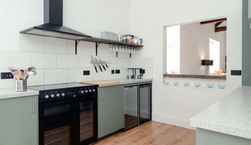 WEll eqipped modern geay and white kitchen with range cooker at Railway Rooms Kingussie