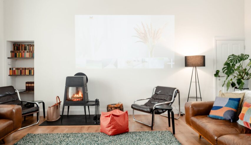 Lounge area with leather sofas and log burner at Railway Rooms Kingussie