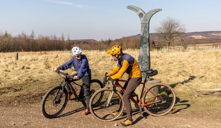 Two cyuclsing on gravle bike on the moors above cote ghyll mill