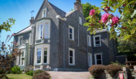 exterior view of moffat hostel with rose flower