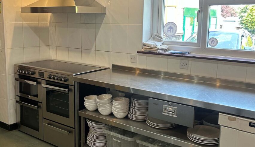 kitchen showing cooker crockery and stainless steel surface at bradwell war memoril hall hostel