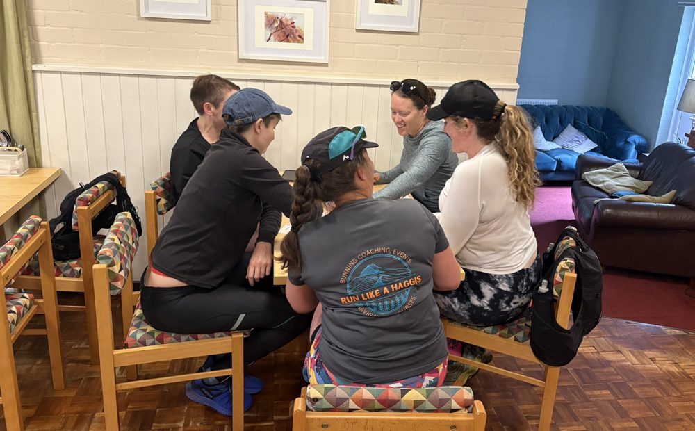 Runners playing board games at Alston Youth Hostel