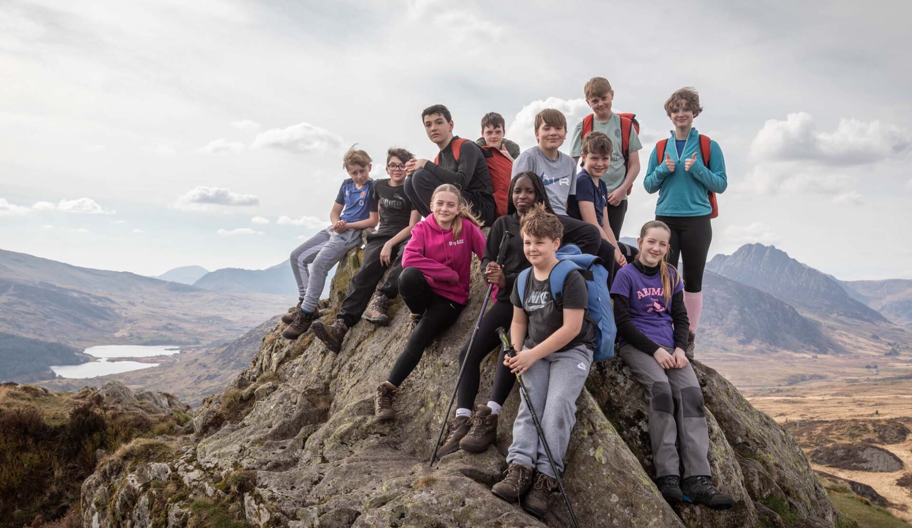 Karl Midlane school at Blue Peris on Sharnbrook hill. Photos of children standing on a craggy hilltop.