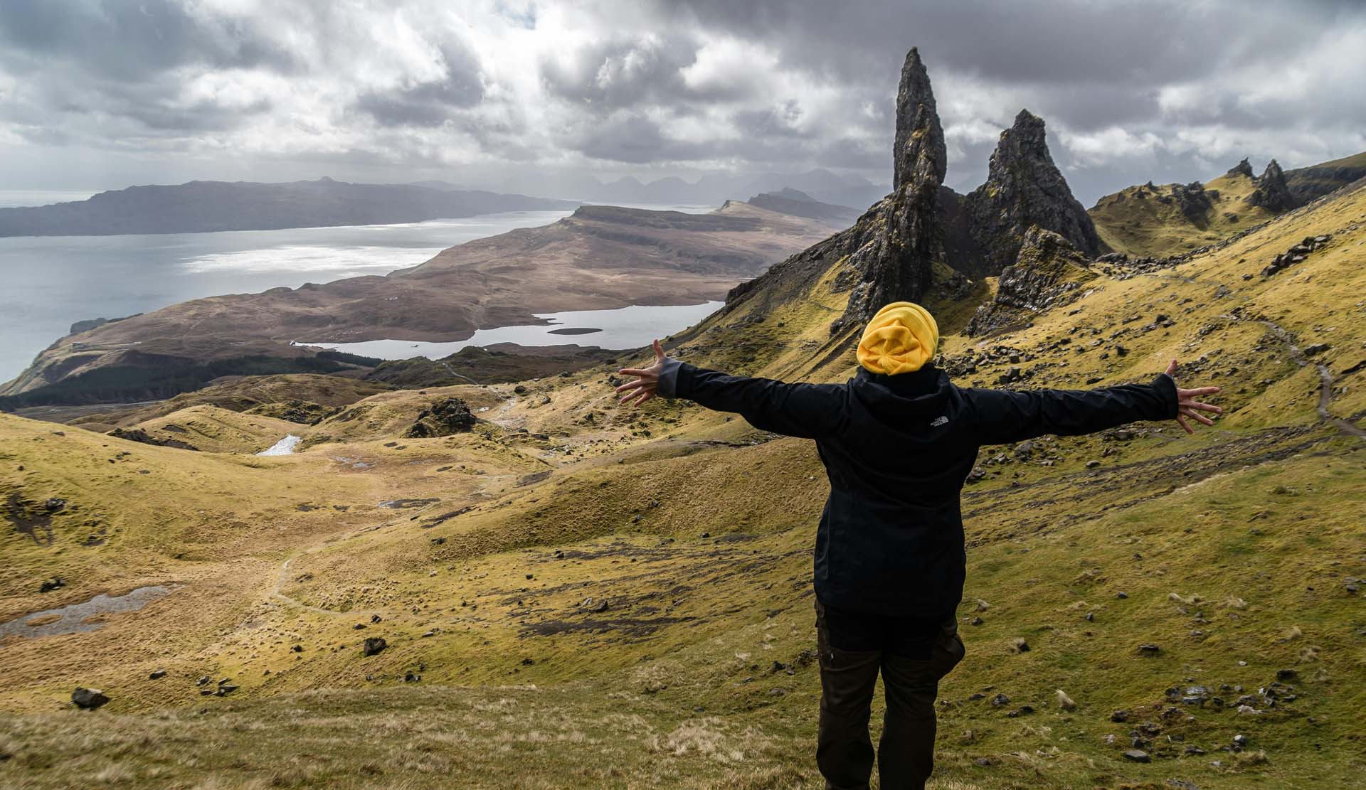 Girls with a yellow wooly hat on embracing scottish scenery overlooking Natioanl Trust for Scotland bunkhouse