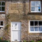 outside view of the front of the cottage showing door and 4 windows at cosy Cottage in Youlgreave