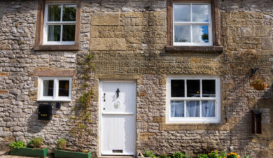 outside view of the front of the cottage showing door and 4 windows at cosy Cottage in Youlgreave