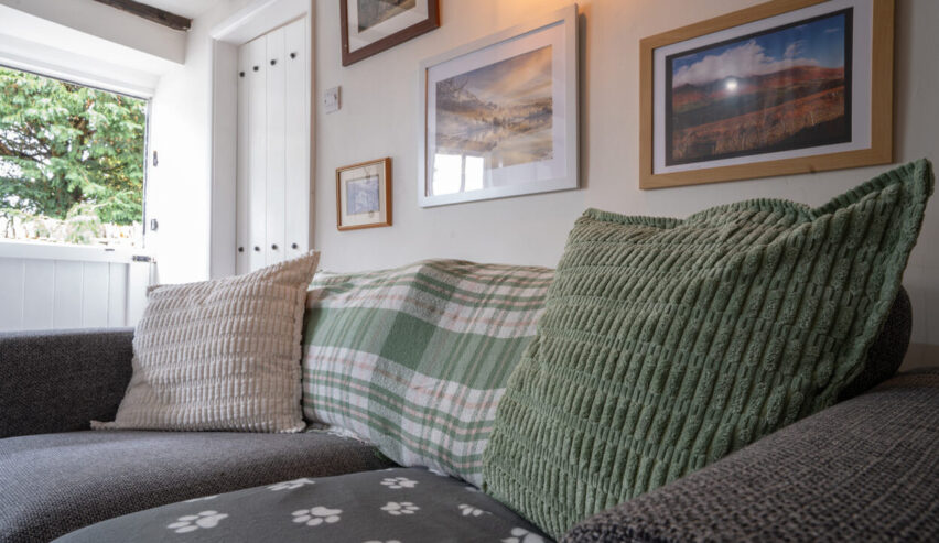 comfy sofa at and pictures on the wall cosy Cottage in Youlgreave