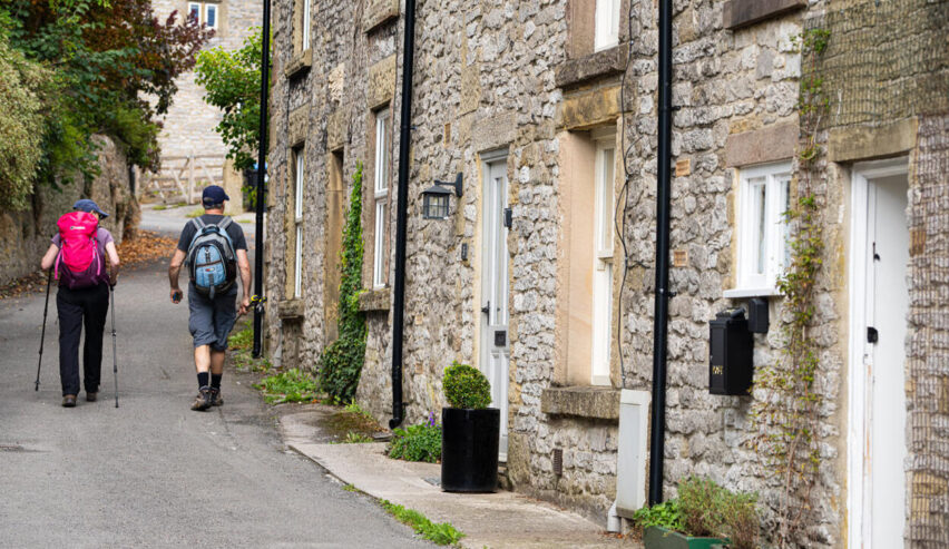 Walkers passing by cosy Cottage in Youlgreave