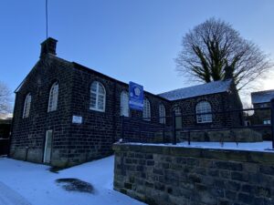 a snowy hostel exterior