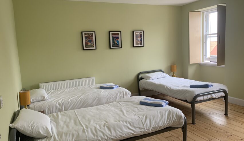 single beds in a private room at Dolphin Dunbar Hostel