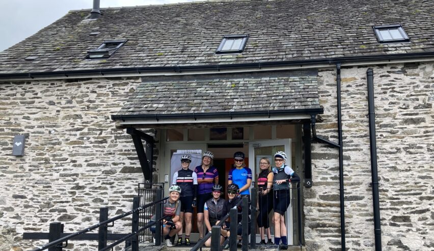 group of cyclists with helmits and lycra on outside Witherslack Cycle Barn
