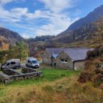 ya hafod hostel with mountain scenery in the background and mini buses in the car park