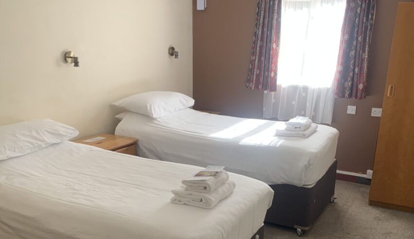 twin beds in a private bedroom at the nightingale centre