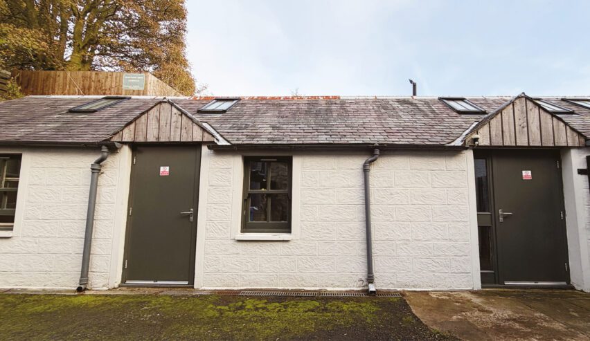 exterior of Hopetoun Bothy on the southern upland way with autumn trees
