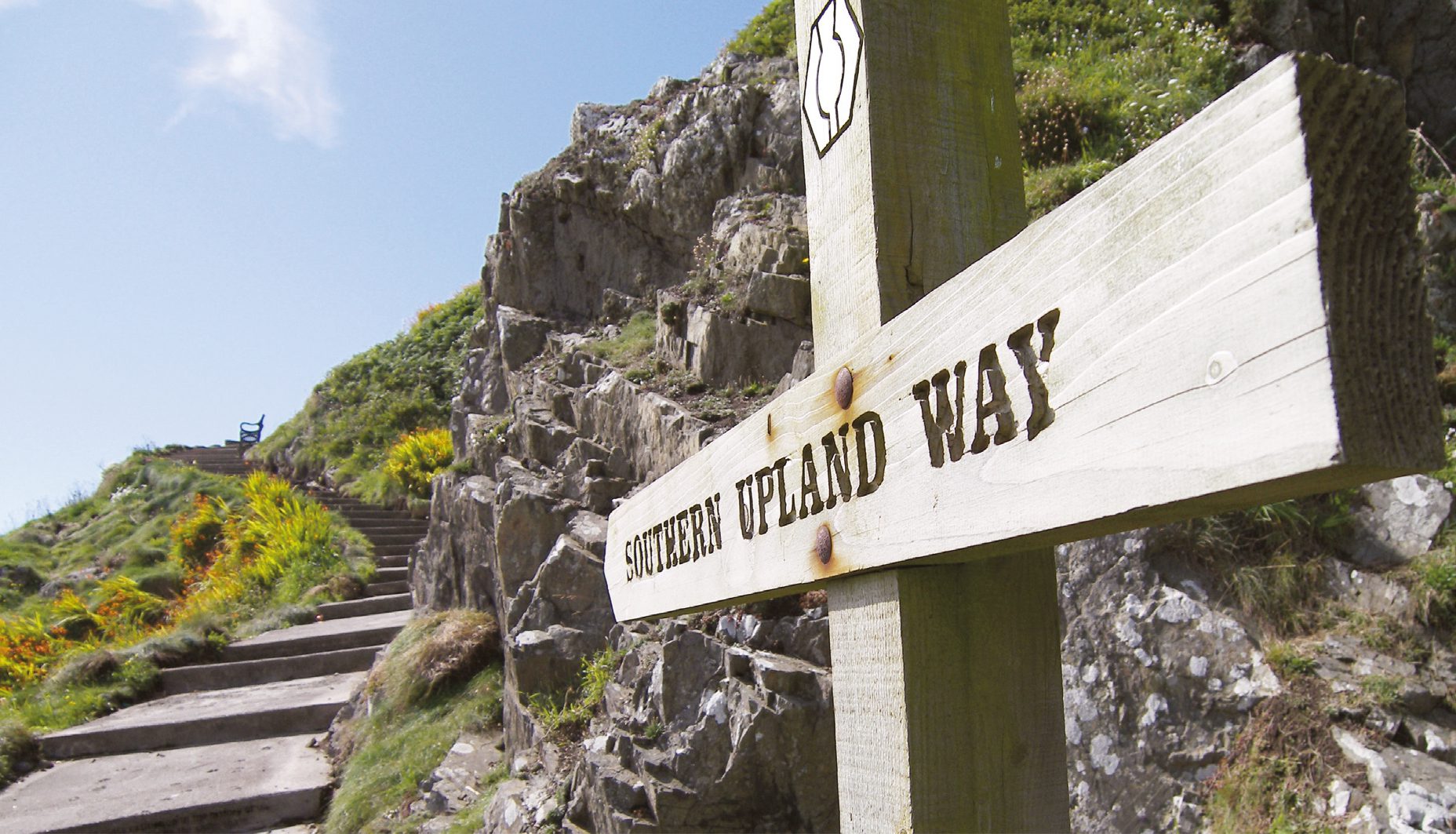 footpath with steps grass and countryseide and a sign saying Southern Upland Way