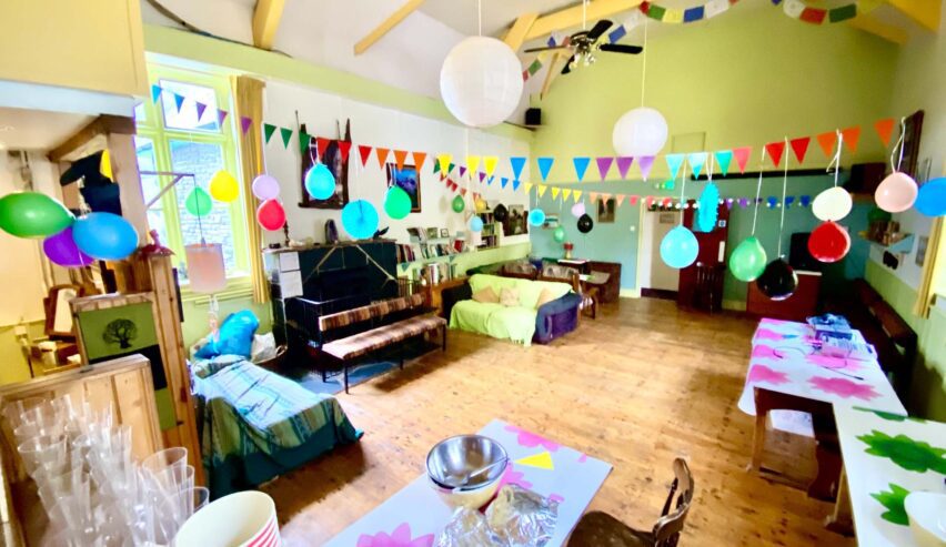 corris hostel hall dressed up for a party with ballones and streamers