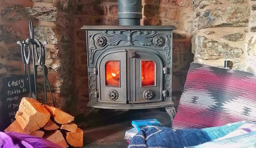 log burner glowing with fire at rocks at plas curig