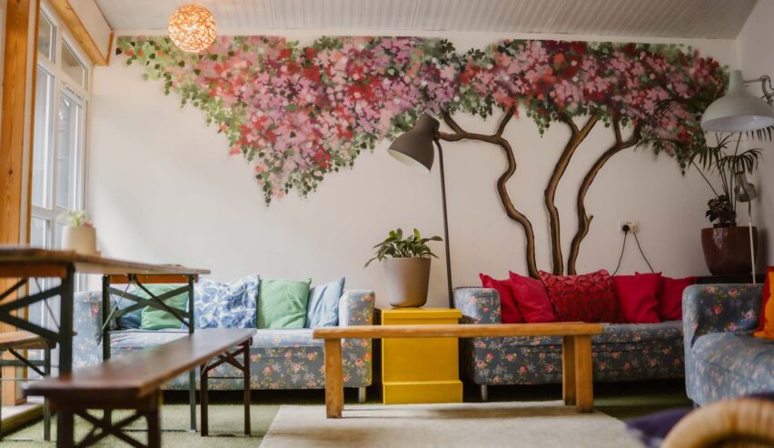 lounge at igloo hostel showing sofas an murials on the wall