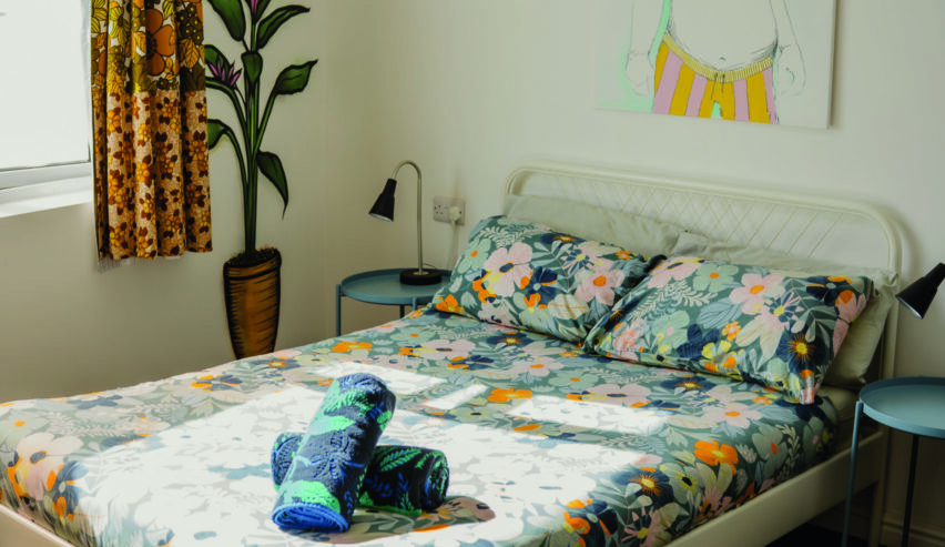 double bed in private room at igloo hostel showing painting on the walls