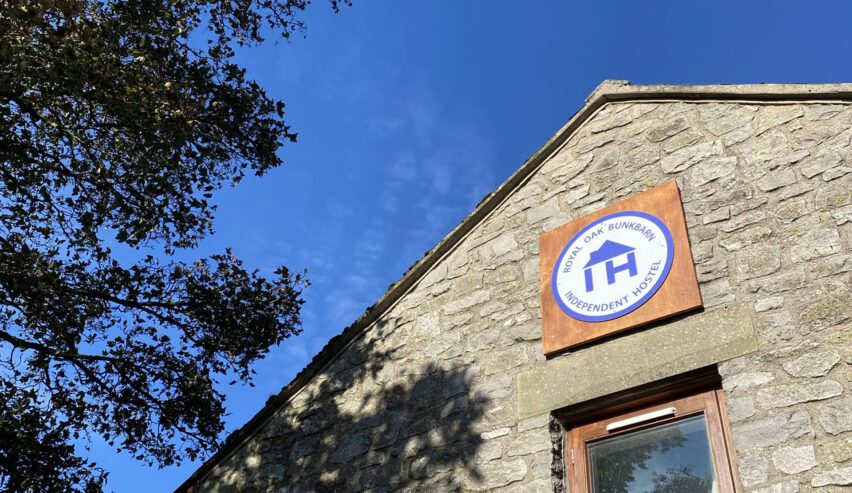 Independent Hostels UK sign on the gable end of royal oak bunkbarn