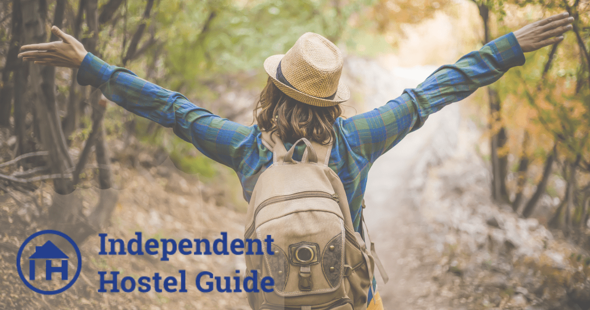 Backpackers with arms in the air celebrating the Independent Hostels Network and the Independent Hostel Guide
