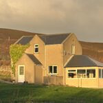 hostel in the evening sunlight on the orkney island of rousay