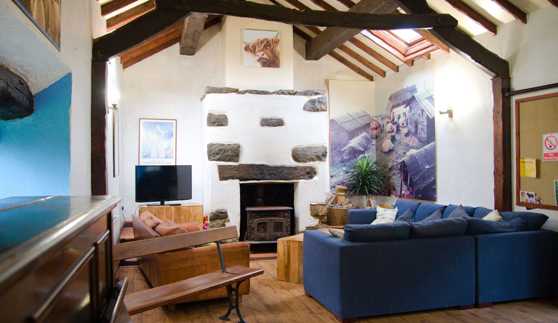 comfy sofas around the log burner at conwy valley backpackers barn