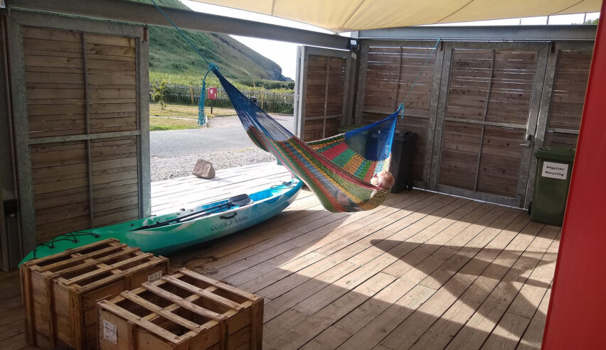 Ty Cwch Boathouse hammock with a view and stored canoe