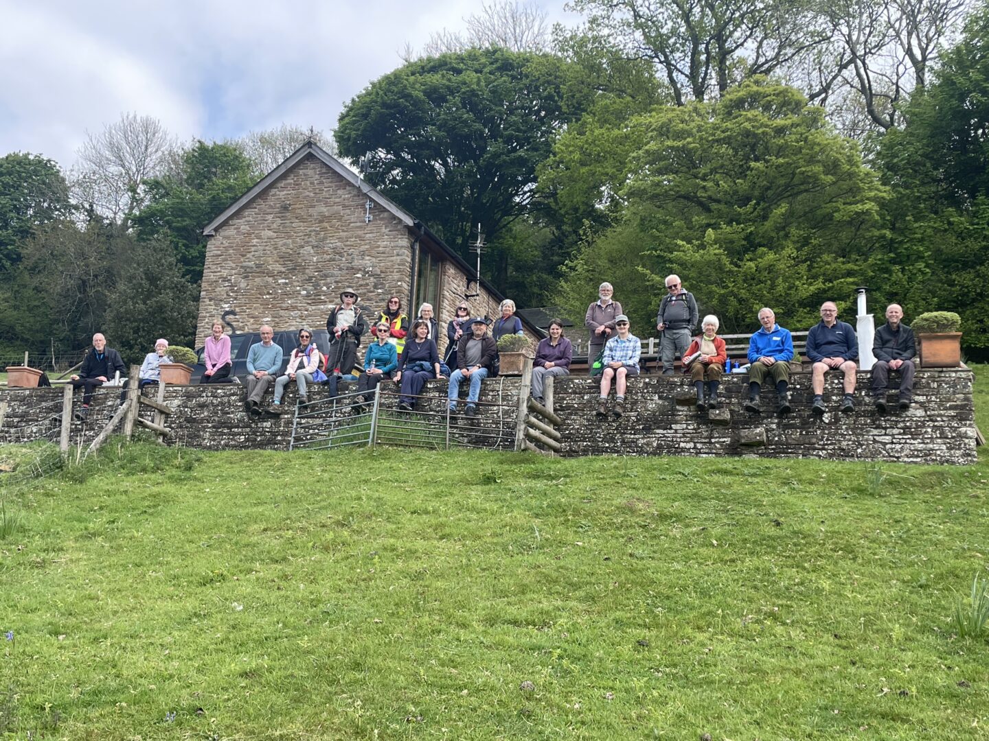 walkers sat on a wall taking prt in chepstow walking festival