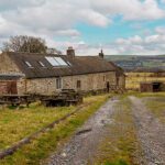Carrs Farm Bunkhouse with blue skye and a backdrop of moorland