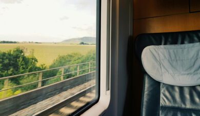 seat on a train showing rural uk countryside through the window