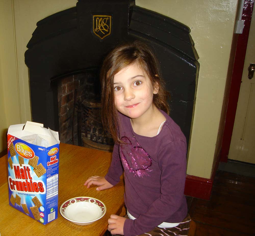 A child at Bridges Hostel showing the Lady of Ratlinghope’s crest carved into the fireplace.